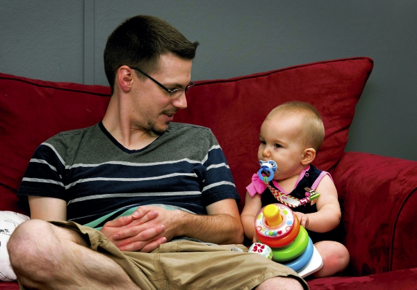 JON C. LAKEY / SALISBURY POST Kevin Blackburn sits on the couch with his 9-month-old daughter Aria. Kevin and Krista Blackburn have been making frequent trips to Philadelphia for cancer treatments for their 9-month-old daughter Aria. At 22-days-old, doctors found evidence of tumors on the back of Aria's eye. Retinoblastoma is a rare malignant tumor of the retina affecting young children. Kevin, Aria's father , suffer from the same affliction, and eventually lost his left eye to problems with the disease. Wednesday, August 3, 2016, in Kannapolis, N.C.